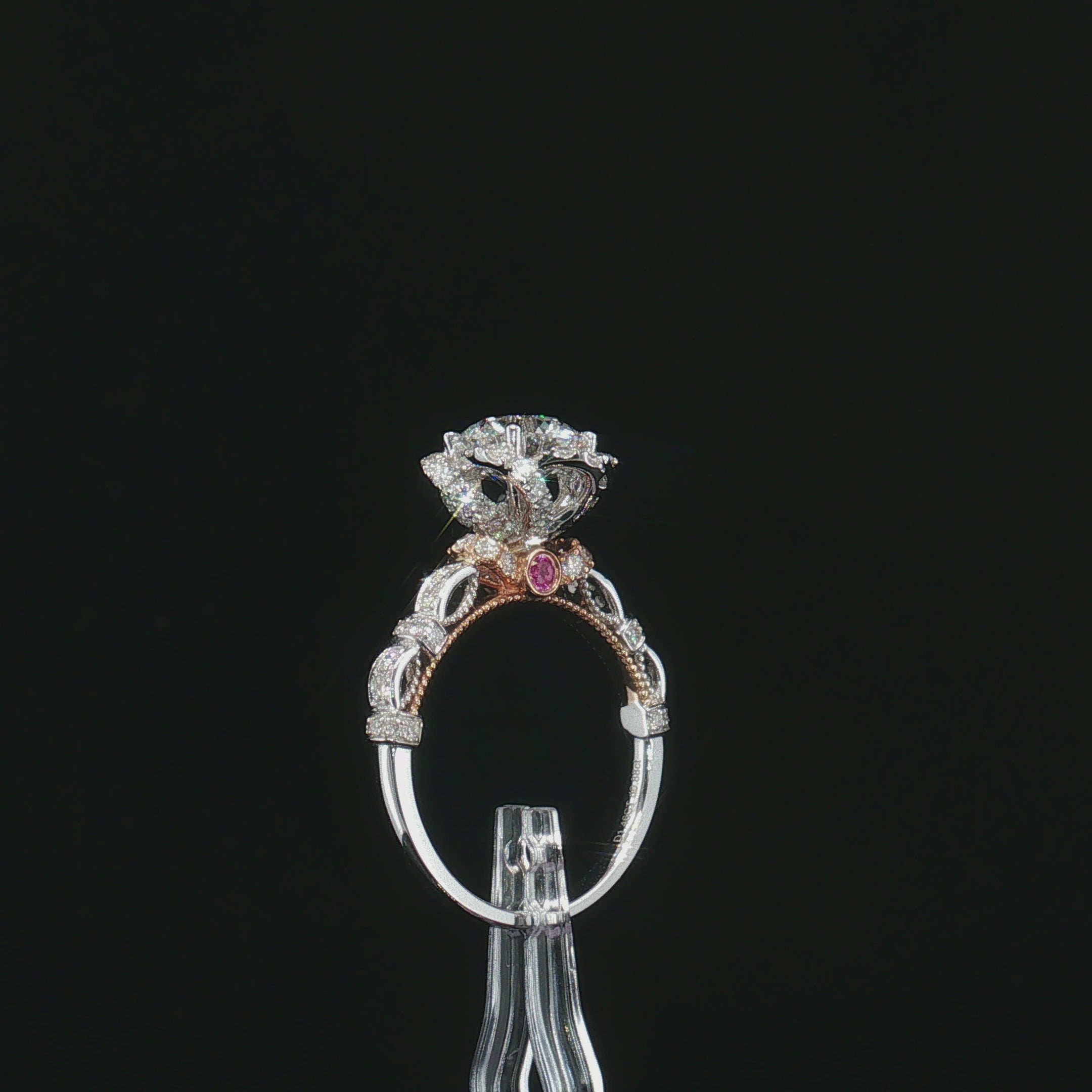 Rear gallery view of the floral halo ring with openwork shoulders and a rose-tone accent stone